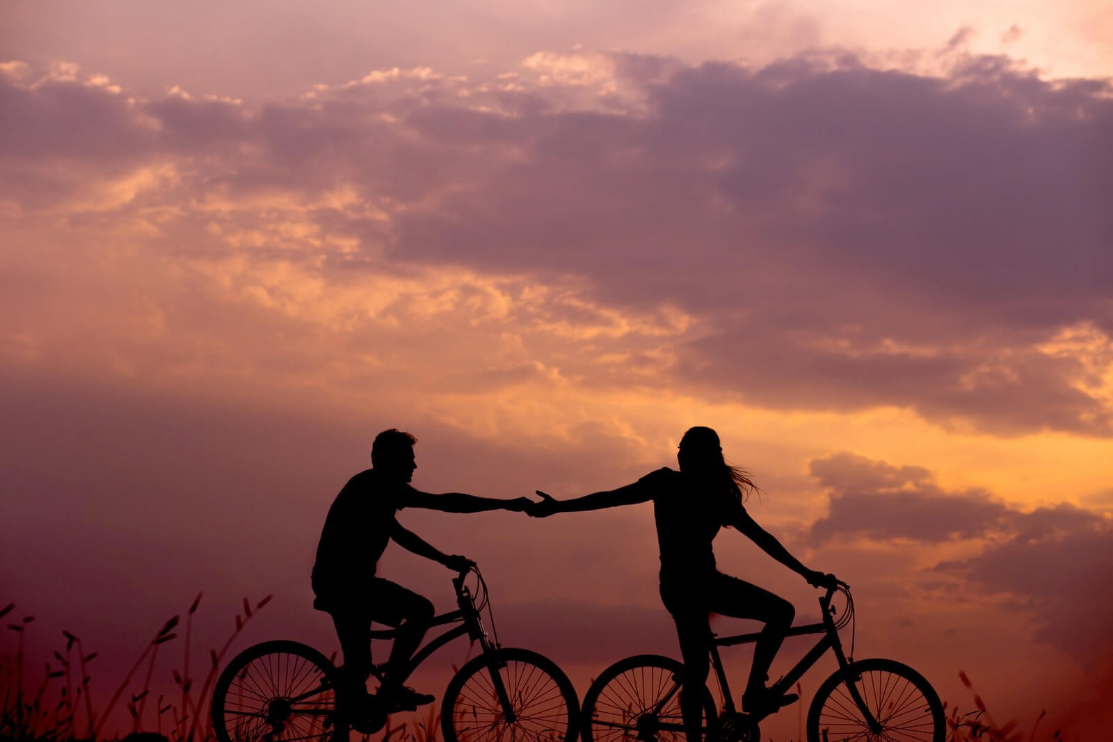 Woman on Bike Reaching Out